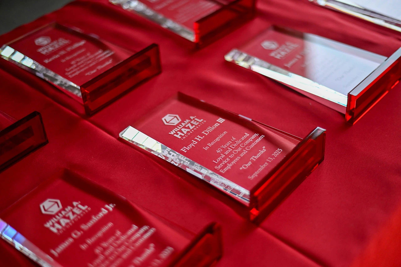 Years of Service award plaques lined up on a red table, which are given out to William A Hazel employees for their loyalty to our site development company