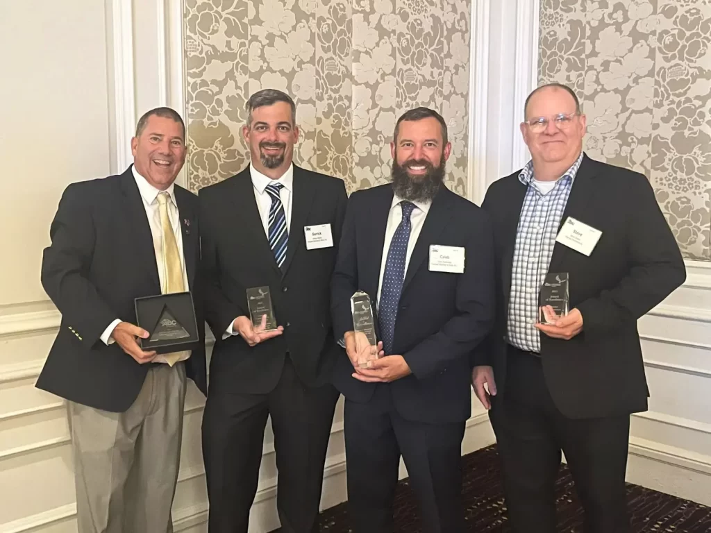 Four members of the William A. Hazel team, which is a site development company in Northern VA, accepting the ABC-VA awards of excellence