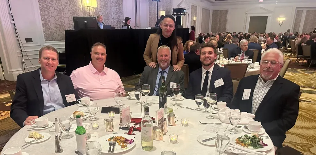 Six members of the William A. Hazel team at a table during the ceremony for the ABC-VA awards of excellence